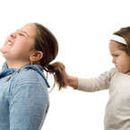 young girl pulling another's hair